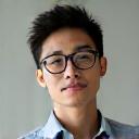 A portrait of Mr. David Chen, a history teacher, looking thoughtful.